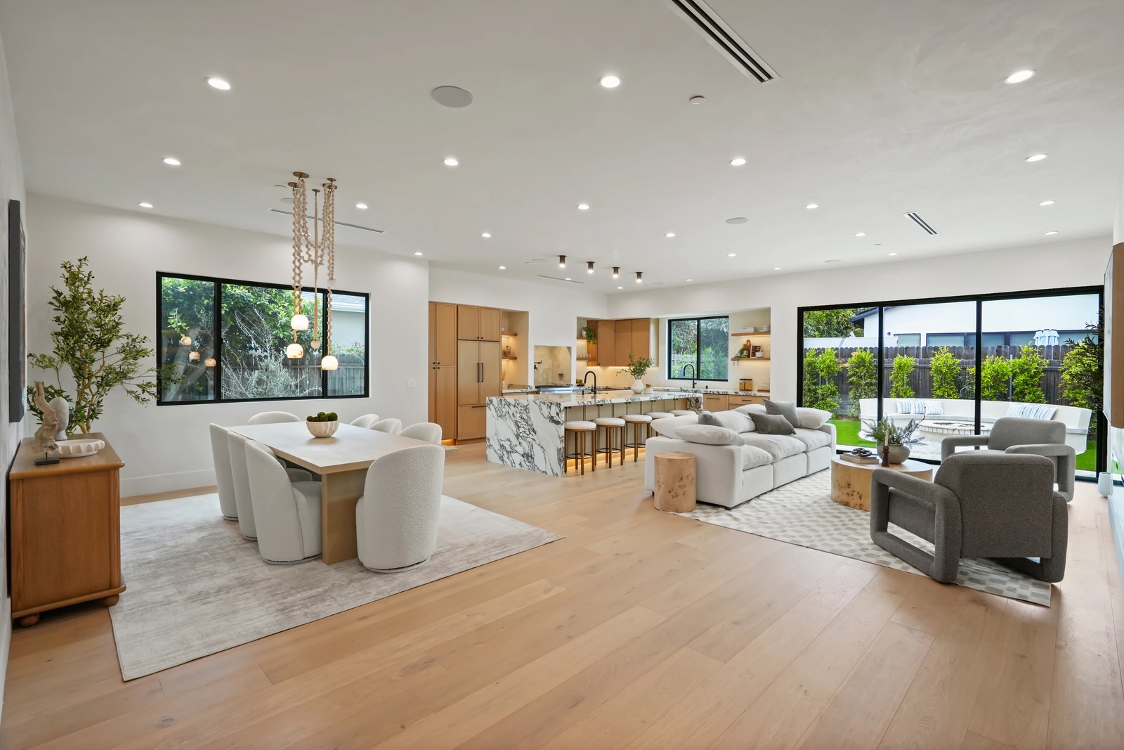 Open-concept great room with marble waterfall island and white oak floors, luxury home in Encino